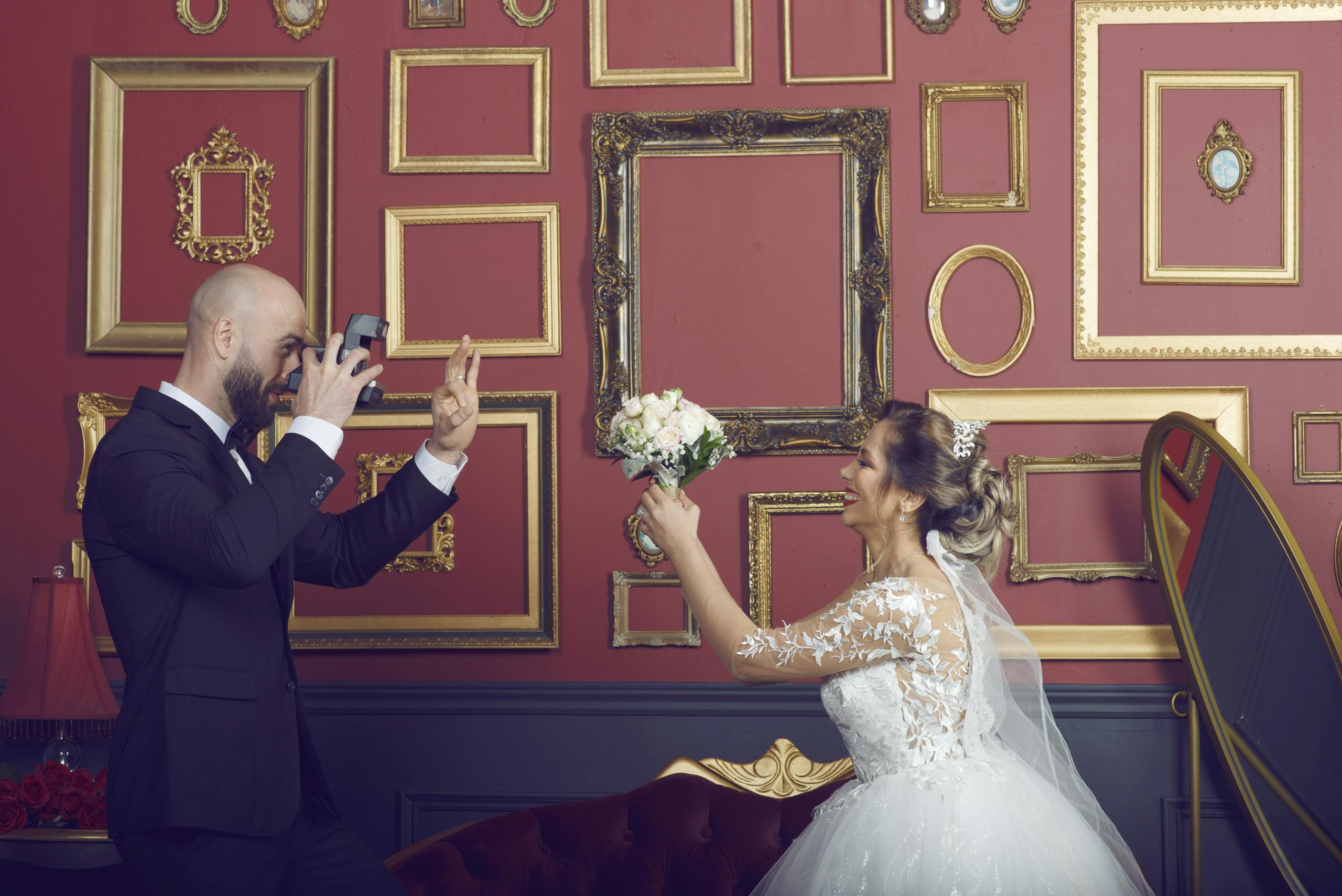 A fun wedding photo depicting a bride and groom in a vintage-themed room.